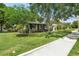 Inviting single Gathering home with a lush green lawn, mature trees, and a charming exterior at 1701 Canton Street, Orlando, FL 32803