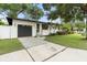 Attractive single Gathering home with black garage door, beautiful palms, and lush front lawn at 1701 Canton Street, Orlando, FL 32803