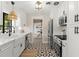 Bright kitchen boasts white cabinetry, modern appliances, and unique geometric tile flooring at 1701 Canton Street, Orlando, FL 32803