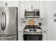 A well-appointed kitchen with stainless steel appliances, ample cabinetry, and stylish subway tile backsplash at 1701 Canton Street, Orlando, FL 32803