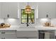 The kitchen features a farmhouse sink with black hardware and stylish subway tile backsplash at 1701 Canton Street, Orlando, FL 32803
