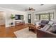 Spacious living room features hardwood floors, large TV, plush seating, and modern decor at 1701 Canton Street, Orlando, FL 32803