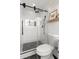 Modern shower featuring white tile, sleek black hardware, and elegant glass door at 1701 Canton Street, Orlando, FL 32803