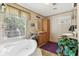 Bathroom with a soaking tub, dual sinks, and a large window that provides lots of natural light at 2229 N 6Th St, Orlando, FL 32820