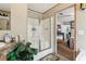 Bathroom with a glass shower, a single sink, and a mirror, with a view into the bedroom area at 2229 N 6Th St, Orlando, FL 32820