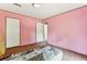 A pink bedroom featuring carpeted floors and two white doors, one of which is open at 2229 N 6Th St, Orlando, FL 32820