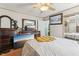 Spacious bedroom featuring a large bed, wood-toned furniture and ensuite bathroom at 2229 N 6Th St, Orlando, FL 32820