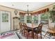 A sunlit dining room with a large window and wooden table set, creating a warm and inviting atmosphere at 2229 N 6Th St, Orlando, FL 32820