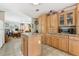 Bright kitchen featuring light wood cabinets, laminate countertops, and an island with visible breakfast bar at 2229 N 6Th St, Orlando, FL 32820