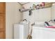 The laundry room has a washer, dryer, wooden cabinets, and a wire shelf above the appliances at 2229 N 6Th St, Orlando, FL 32820