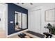 Stylish bedroom features a navy accent wall, exercise equipment, and mirrors to expand the feel of the space at 2291 Mossy Vine Ave, St Cloud, FL 34771