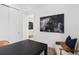 Another view of the office space with a black desk and striking wall art at 2291 Mossy Vine Ave, St Cloud, FL 34771