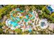 Breathtaking aerial view of a resort-style pool area with lush landscaping and plenty of lounge seating at 304 Muirfield Loop, Reunion, FL 34747