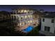 Luxury home with a multi-tiered balcony overlooking a private pool, spa, and outdoor dining area at 304 Muirfield Loop, Reunion, FL 34747