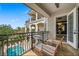 Balcony with seating overlooking a pool and manicured landscape at 304 Muirfield Loop, Reunion, FL 34747