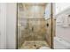 Elegant bathroom featuring a glass-enclosed shower with beautiful tile work and modern fixtures at 304 Muirfield Loop, Reunion, FL 34747
