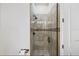 Modern bathroom featuring tiled shower with glass door and stylish fixtures at 304 Muirfield Loop, Reunion, FL 34747