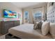 Well-lit bedroom featuring a cozy bed, a dresser with TV, and a door leading to a balcony at 304 Muirfield Loop, Reunion, FL 34747