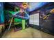Whimsical bedroom with a spaceship themed bed and space mural for an imaginative atmosphere at 304 Muirfield Loop, Reunion, FL 34747
