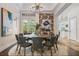 Elegant dining room featuring a round table, stylish chairs, and unique accent wall with artful décor at 304 Muirfield Loop, Reunion, FL 34747