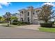 Beautiful two-story home with balconies, a tile roof, and a well-manicured lawn in a suburban neighborhood at 304 Muirfield Loop, Reunion, FL 34747