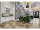Elegant foyer with wallpaper, staircase, stone floors, and a built-in bar area at 304 Muirfield Loop, Reunion, FL 34747