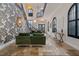 Stunning foyer with soaring ceilings, detailed wallpaper, stone floors, and an elegant staircase with iron railings at 304 Muirfield Loop, Reunion, FL 34747