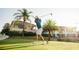 Golfer teeing off in front of a beautiful home, showcasing the community's golf course and lifestyle at 304 Muirfield Loop, Reunion, FL 34747