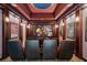 Luxurious home theater with comfortable seating, movie posters, and a large projection screen for entertainment at 304 Muirfield Loop, Reunion, FL 34747