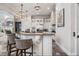 Spacious kitchen featuring stone floors, an island with bar seating, granite countertops, and stainless steel appliances at 304 Muirfield Loop, Reunion, FL 34747