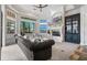 Spacious living room featuring a fireplace, large windows, neutral decor, and an adjacent breakfast area at 304 Muirfield Loop, Reunion, FL 34747