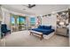 Spacious bedroom with a king-size bed, accent wall, and sliding glass doors to a balcony at 304 Muirfield Loop, Reunion, FL 34747