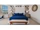 Beautiful bedroom with a king bed and a bench, complemented by decorative bedside tables and lamps at 304 Muirfield Loop, Reunion, FL 34747