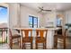 Outdoor bar area with tiled countertops, wooden chairs, and a scenic view, perfect for entertaining guests at 304 Muirfield Loop, Reunion, FL 34747