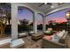 Inviting covered patio with ample seating, ideal for enjoying tranquil sunsets in style and comfort at 304 Muirfield Loop, Reunion, FL 34747