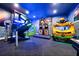 Extravagant playroom features a slide, arcade games, and a Transformers themed area for entertainment at 304 Muirfield Loop, Reunion, FL 34747