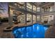 Stunning backyard pool with spa, surrounded by manicured landscaping and inviting lounge furniture at 304 Muirfield Loop, Reunion, FL 34747