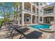 Luxury home featuring a pool and lounge area with an outdoor kitchen, ideal for entertaining guests at 304 Muirfield Loop, Reunion, FL 34747
