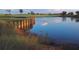 Scenic water view reflecting the lush greenery and the manicured landscape of the golf course at 304 Muirfield Loop, Reunion, FL 34747