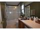 Bathroom featuring shower-tub, window, and dark green walls at 3055 Leflore Ln, Orlando, FL 32833
