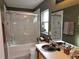 Cozy bathroom featuring a tub and shower combination and stylish fixtures at 3055 Leflore Ln, Orlando, FL 32833