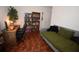 This room contains a work desk, wooden bookshelf, and a gray futon-style bed at 3055 Leflore Ln, Orlando, FL 32833