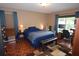 Comfortable bedroom featuring warm lighting and functional desk space at 3055 Leflore Ln, Orlando, FL 32833