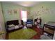 Bright Bedroom with a crib, accent chair, and fun wall decals at 3055 Leflore Ln, Orlando, FL 32833
