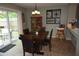 Warm dining space with a dark table, backyard views, and light green walls at 3055 Leflore Ln, Orlando, FL 32833