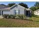 Lovely single story home with a neatly landscaped yard and gray paint, offering great curb appeal at 3055 Leflore Ln, Orlando, FL 32833