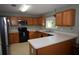Well-equipped kitchen with stainless steel refrigerator and light wood cabinets at 3055 Leflore Ln, Orlando, FL 32833