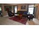 Comfortable living room featuring tile flooring, a leather sofa, and natural light at 3055 Leflore Ln, Orlando, FL 32833