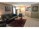 Comfortable living room featuring tile flooring, dark leather sofa, and a welcoming atmosphere at 3055 Leflore Ln, Orlando, FL 32833