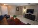 Comfortable living room featuring neutral walls, a large television, and stylish decor at 3055 Leflore Ln, Orlando, FL 32833